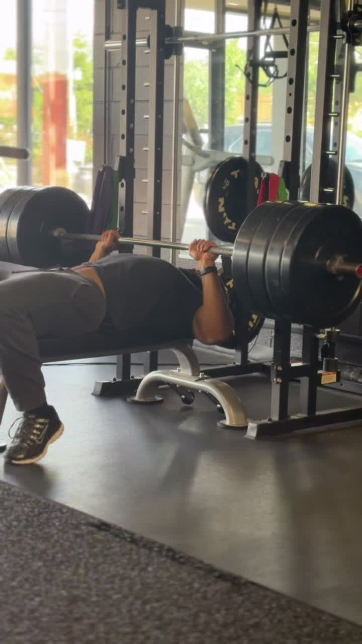 Lifter performing a heavy barbell bench press